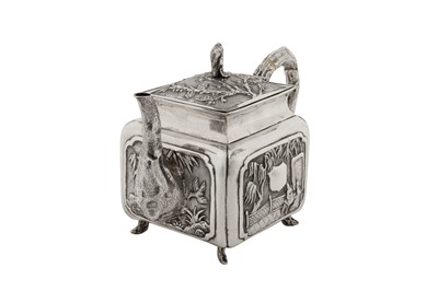 Lot 187 - An early 20th century Chinese export silver three-piece tea service, Canton circa 1920 by Qiao Zhen, retailed by Cum Wo of Hong Kong