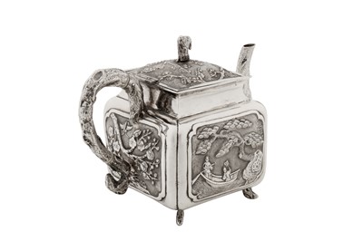 Lot 187 - An early 20th century Chinese export silver three-piece tea service, Canton circa 1920 by Qiao Zhen, retailed by Cum Wo of Hong Kong