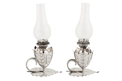 Lot 381 - A pair of Victorian sterling silver oil lamp chambersticks, Birmingham 1892 by Hukin and Heath, one marked for Samuel Smith