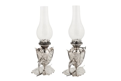Lot 381 - A pair of Victorian sterling silver oil lamp chambersticks, Birmingham 1892 by Hukin and Heath, one marked for Samuel Smith