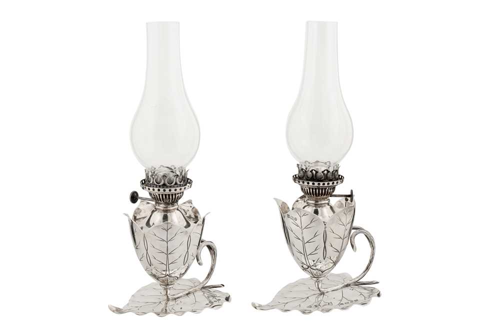 Lot 381 - A pair of Victorian sterling silver oil lamp chambersticks, Birmingham 1892 by Hukin and Heath, one marked for Samuel Smith