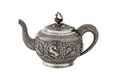 Lot 116 - A late 19th / early 20th century Anglo - Indian unmarked silver teapot, Madras circa 1900
