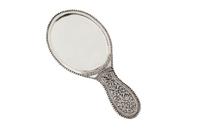 Lot 107 - An early 20th century Anglo – Indian unmarked silver hand mirror, Cutch circa 1910