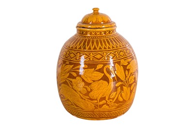 Lot 204 - AN AMBER-GLAZED SLIP-DECORATED 'CRANES AND LOTUS' JAR AND COVER