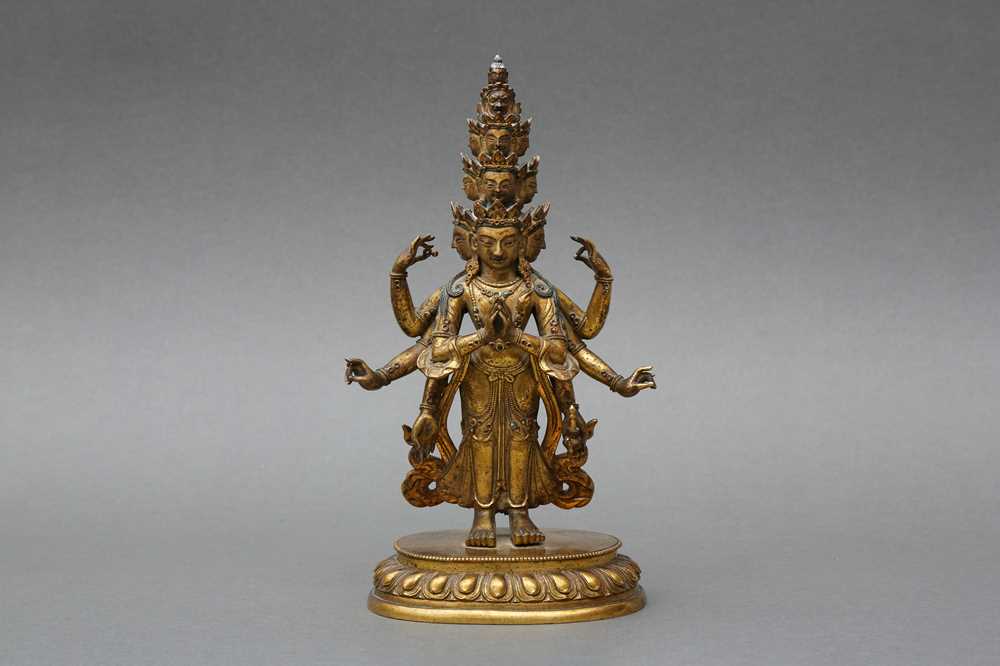 Lot 181 - A SINO-TIBETAN GILT-BRONZE FIGURE OF ELEVEN-HEADED EKADASAMUKHA AVALOKITESHVARA