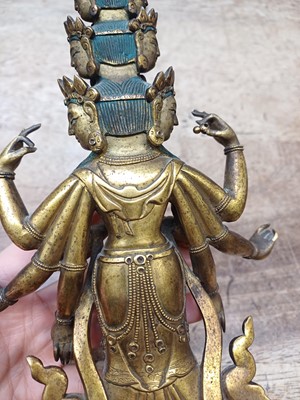 Lot 181 - A SINO-TIBETAN GILT-BRONZE FIGURE OF ELEVEN-HEADED EKADASAMUKHA AVALOKITESHVARA