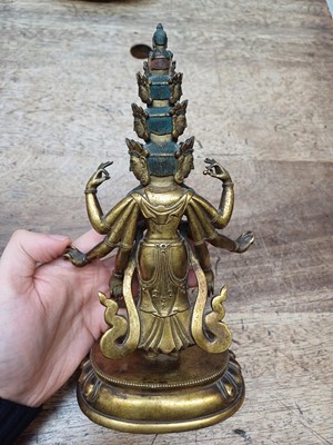 Lot 181 - A SINO-TIBETAN GILT-BRONZE FIGURE OF ELEVEN-HEADED EKADASAMUKHA AVALOKITESHVARA