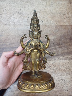 Lot 181 - A SINO-TIBETAN GILT-BRONZE FIGURE OF ELEVEN-HEADED EKADASAMUKHA AVALOKITESHVARA