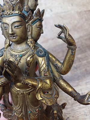 Lot 181 - A SINO-TIBETAN GILT-BRONZE FIGURE OF ELEVEN-HEADED EKADASAMUKHA AVALOKITESHVARA