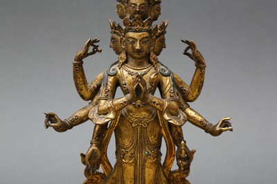 Lot 181 - A SINO-TIBETAN GILT-BRONZE FIGURE OF ELEVEN-HEADED EKADASAMUKHA AVALOKITESHVARA