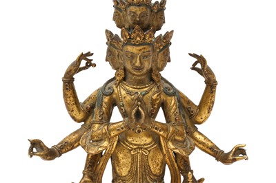 Lot 181 - A SINO-TIBETAN GILT-BRONZE FIGURE OF ELEVEN-HEADED EKADASAMUKHA AVALOKITESHVARA