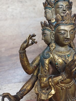 Lot 181 - A SINO-TIBETAN GILT-BRONZE FIGURE OF ELEVEN-HEADED EKADASAMUKHA AVALOKITESHVARA