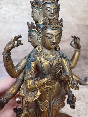 Lot 181 - A SINO-TIBETAN GILT-BRONZE FIGURE OF ELEVEN-HEADED EKADASAMUKHA AVALOKITESHVARA