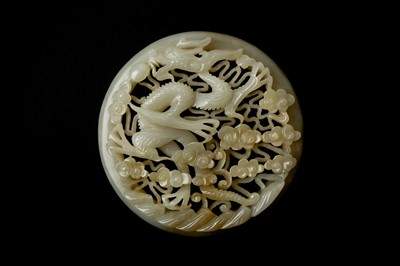 Lot 133 - A CHINESE RETICULATED WHITE AND RUSSET JADE 'DRAGON' ROUND PLAQUE