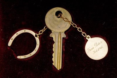 Lot 22 - A KEY WITH HOLDER