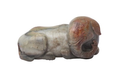 Lot 560 - A CHINESE PALE-CELADON AND RUSSET JADE 'ELEPHANT' CARVING