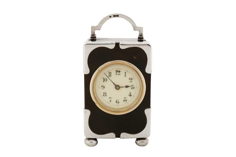 Lot 68 - An Edwardian sterling silver mounted tortoiseshell timepiece or clock, London 1902 by HA
