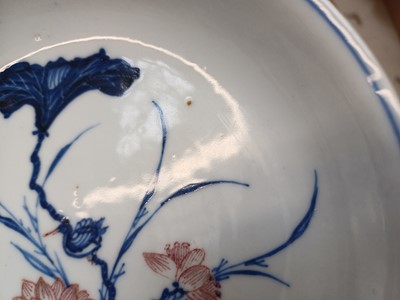 Lot 17 - A RARE CHINESE BLUE AND WHITE AND COPPER-RED 'LOTUS AND EGRET' DISH