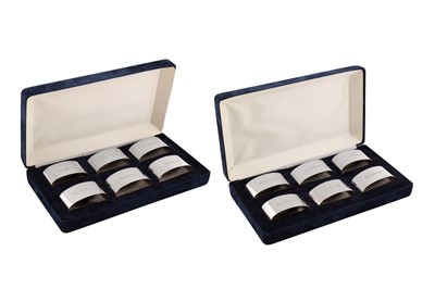 Lot 277 - Two cased sets of Elizabeth II sterling silver napkin rings, Sheffield 2000 by Carrs