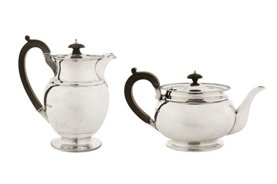 Lot 304 - A George V sterling silver teapot and hot water pot, London 1922 and 1935 by Pairpoint Brothers