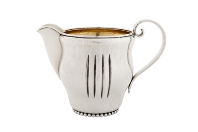 Lot 215 - An early 20th century German sterling silver handmade milk jug, marked Sulzbach