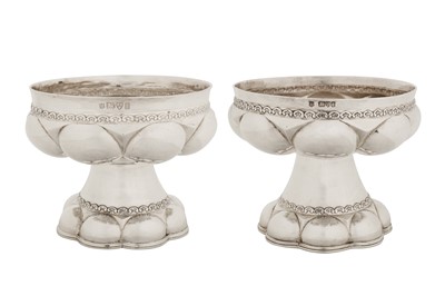 Lot 309 - A pair of Edwardian sterling silver replica flat or font cups, Chester 1905 by Nathan and Hayes