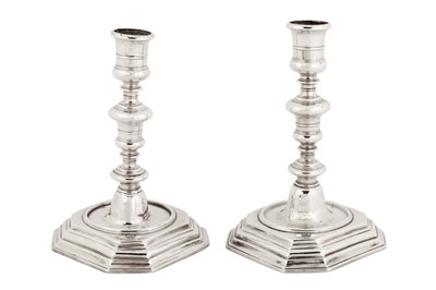 Lot 420 - A pair of Queen Anne Britannia standard silver candlesticks, London 1702 by William Denney (free. 3 Oct 1679, d. 1707)