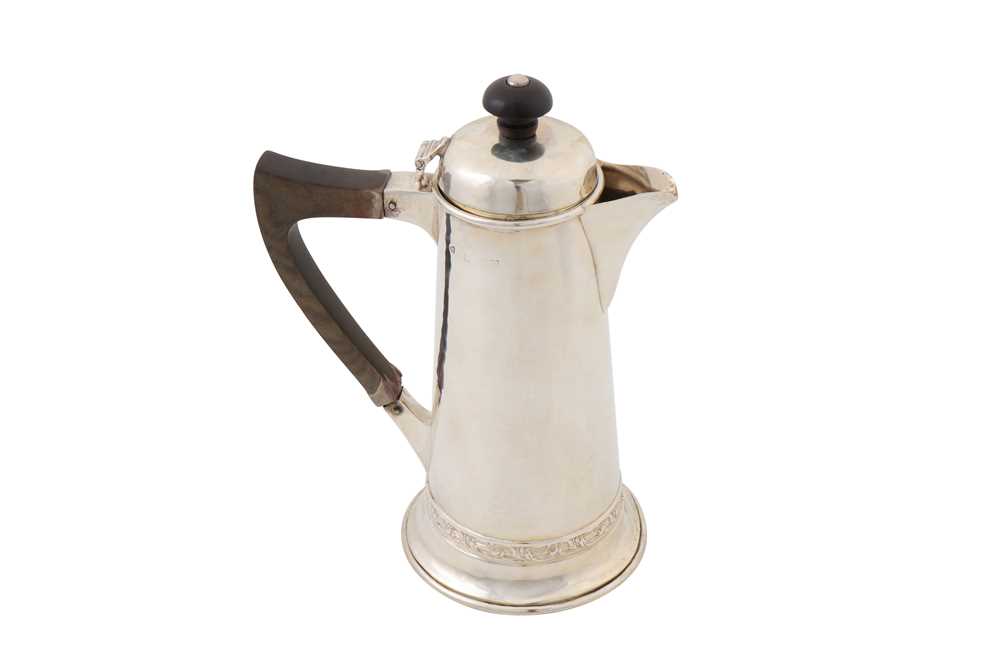 Lot 200 - A George V ‘Arts and Crafts’ sterling silver hot water pot, Birmingham 1920 by A. E. Jones
