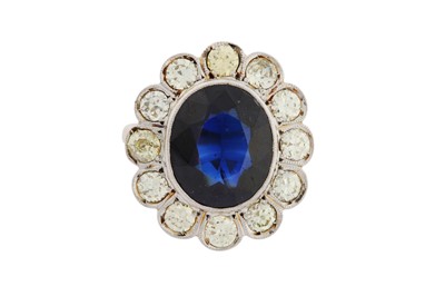 Lot 268 - A SYNTHETIC SAPPHIRE AND DIAMOND CLUSTER RING