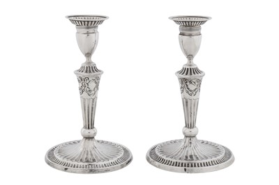 Lot A pair of George III sterling silver candlesticks, London 1789 by RC, Robert Cruickshank? (Grimwade 3765a)