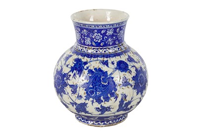 Lot 55 - A BLUE AND WHITE IZNIK-REVIVAL POTTERY VASE WITH CHINESE-INSPIRED LOTUS MOTIF