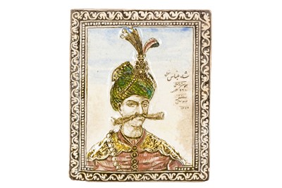 Lot 138 - A QAJAR MOULDED POTTERY TILE DEPICTING SHAH ABBAS THE GREAT (R. 1588-1629)