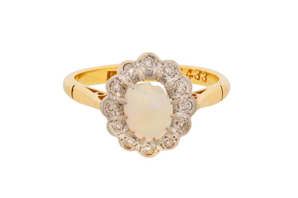 Lot 13 - A WHITE OPAL AND DIAMOND HALO RING