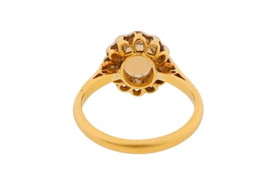Lot 13 - A WHITE OPAL AND DIAMOND HALO RING