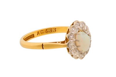Lot 13 - A WHITE OPAL AND DIAMOND HALO RING