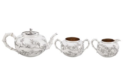 Lot 123 - A late 19th / early 20th century Chinese export silver three-piece tea service, Canton circa 1900, marked Ye Bo, retailed by Wang Hing