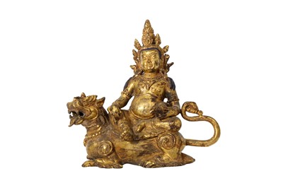 Lot 207 - A SINO-TIBETAN GILT-BRONZE FIGURE OF VAISRAVANA