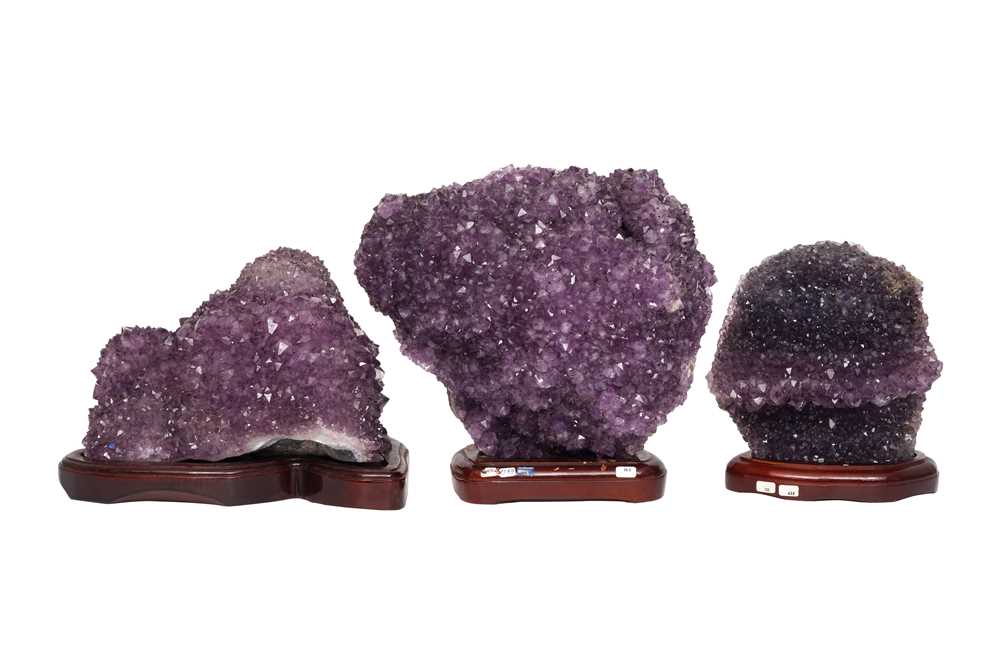 Lot 70 - THREE AMETHYST GEODE CLUSTERS ON STANDS