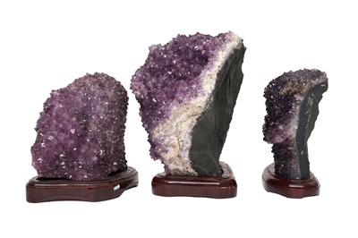 Lot 70 - THREE AMETHYST GEODE CLUSTERS ON STANDS
