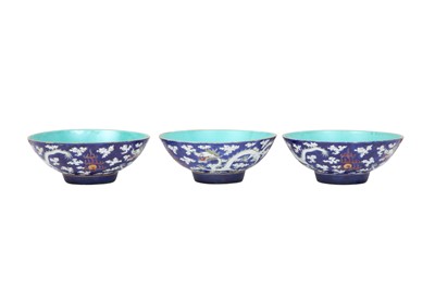 Lot 376 - THREE CHINESE BLUE-GROUND 'DRAGON' BOWLS