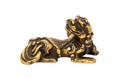 Lot 574 - A CHINESE GILT-BRONZE 'MYTHICAL BEAST' SCROLL WEIGHT