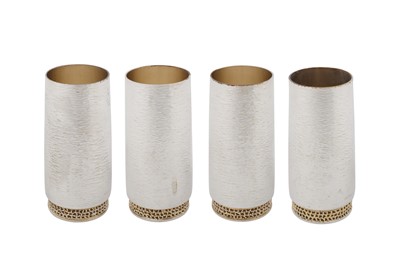 Lot 450 - A set of four Elizabeth II modernist parcel gilt sterling silver beakers, London 1978 by Stuart Devlin (1931-2018)