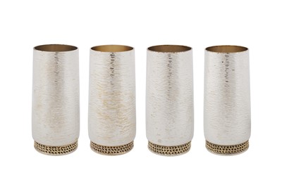 Lot 451 - A set of four Elizabeth II modernist parcel gilt sterling silver beakers, London 1978 by Stuart Devlin (1931-2018)