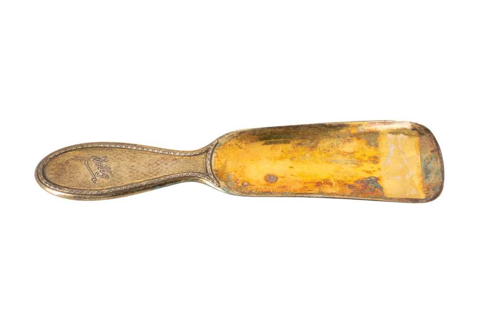 Lot 212 - A George V sterling silver gilt shoehorn, London 1922 by Asprey
