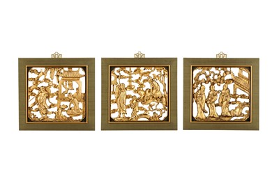 Lot 99 - A SET OF THREE CHINESE CARVED AND GILT-WOOD FRAMED PANELS