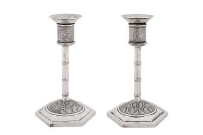 Lot A pair of early 20th century Chinese export silver candlesticks, Shanghai circa 1920, marked Bi Ji, retailed by Wang Hing of Canton and Hong Kong