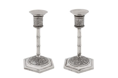 Lot 262 - A pair of early 20th century Chinese export silver candlesticks, Shanghai circa 1920, marked Bi Ji, retailed by Wang Hing of Canton and Hong Kong