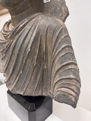 Lot 196 - A LARGE CARVED GANDHARA GREY SCHIST BUST OF THE HISTORICAL BUDDHA, SIDDHARTHA GAUTAMA SHAKYAMUNI