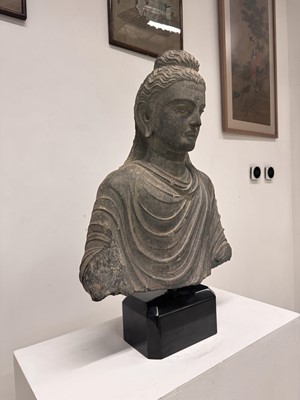 Lot 196 - A LARGE CARVED GANDHARA GREY SCHIST BUST OF THE HISTORICAL BUDDHA, SIDDHARTHA GAUTAMA SHAKYAMUNI