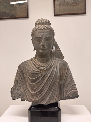 Lot 196 - A LARGE CARVED GANDHARA GREY SCHIST BUST OF THE HISTORICAL BUDDHA, SIDDHARTHA GAUTAMA SHAKYAMUNI